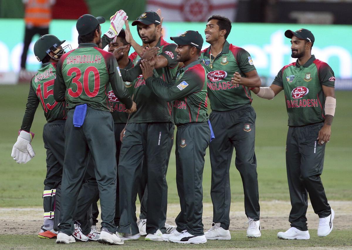 United Arab Emirates cricketers celebrate the dismissal of India's