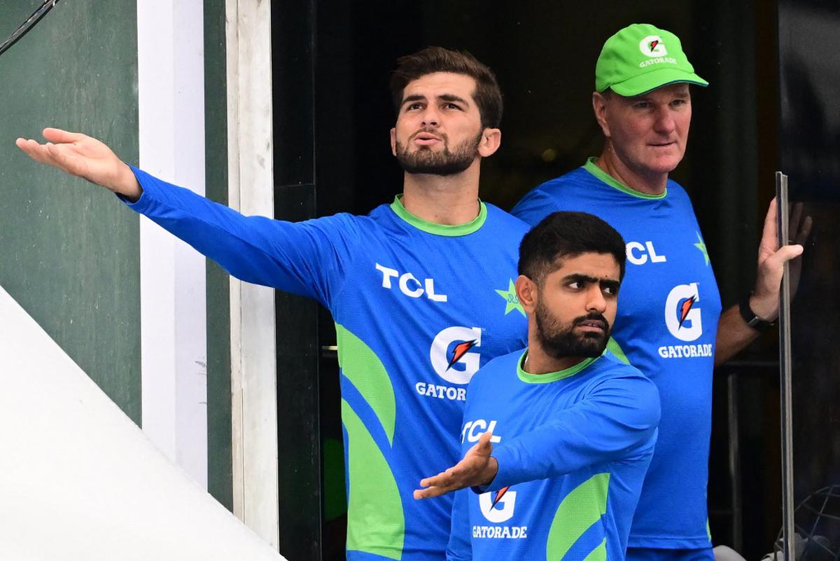 Pakistan’s captain Babar Azam and teammate Shaheen Shah Afridi gesture as rain delays the start of the Asia Cup 2023 super four one-day international (ODI) cricket match against Sri Lanka in Colombo on September 14, 2023.