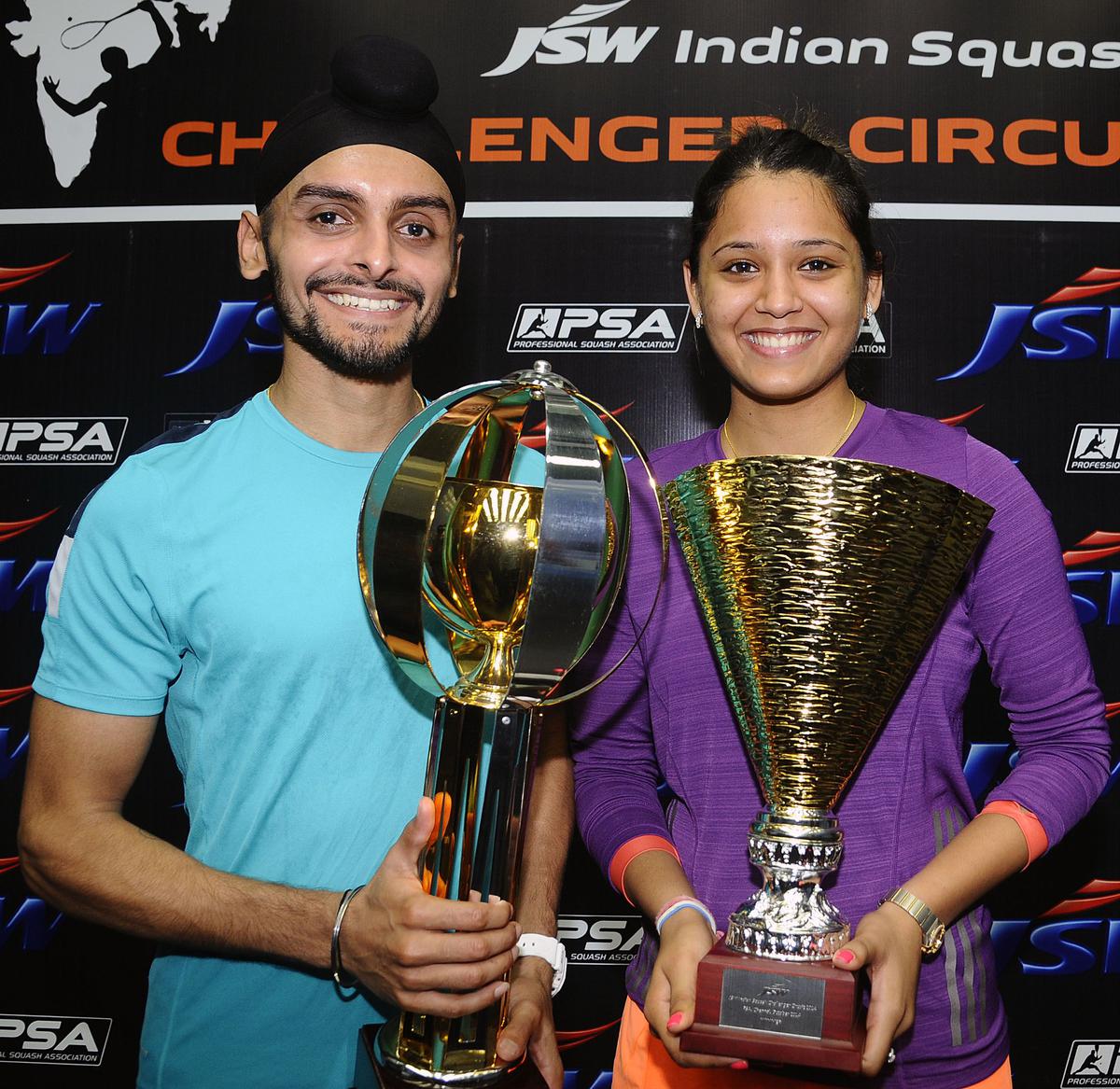 Dipika Pallikal and Harinder Pal Sandhu celebrate with their 2014 WSA Challenger Squash tournament trophies. 