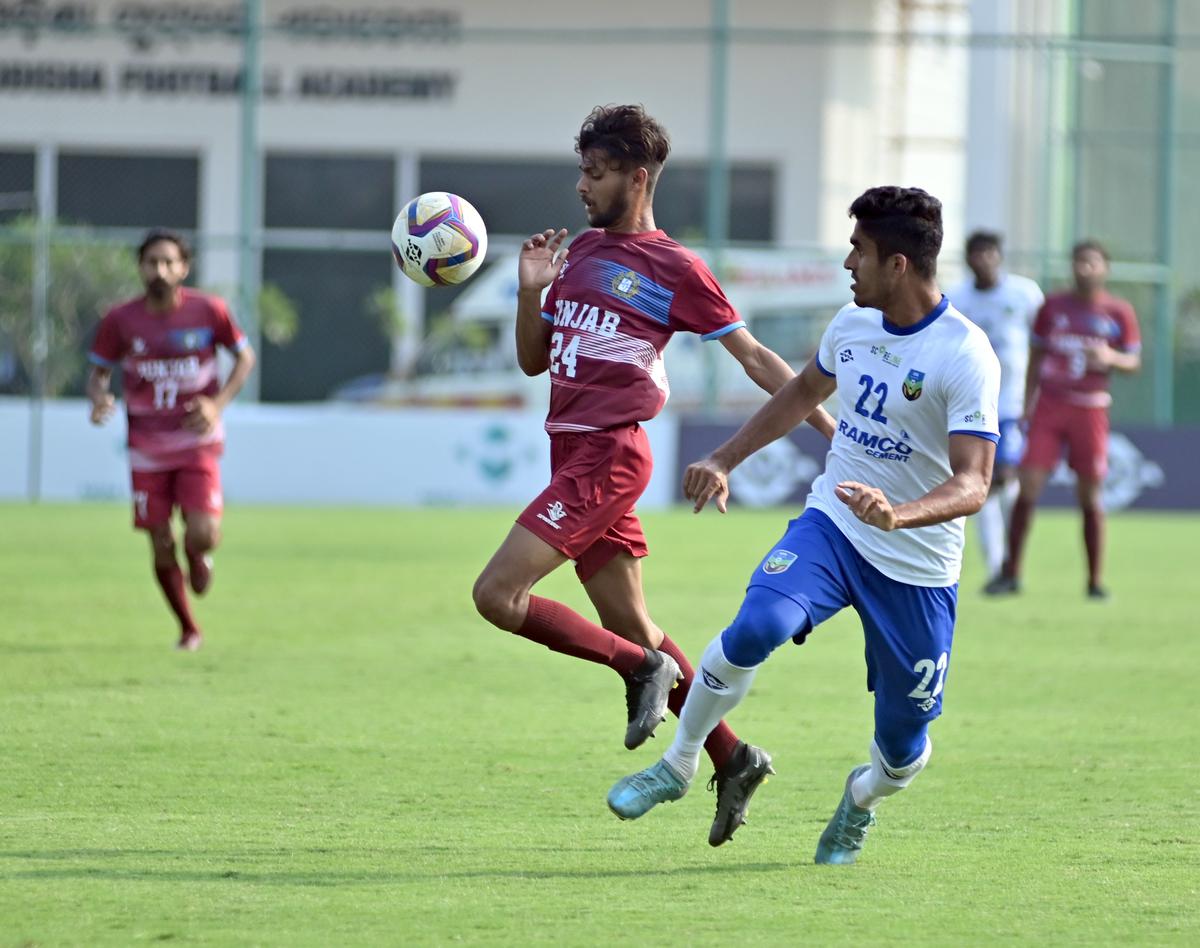 Kerala defender Mohamed Salim (right, white jersey) tries to thwart Punjab forward Kamaldeep in the Santosh Trophy National football championship in Bhubaneswar on Sunday. Photo: AIFF