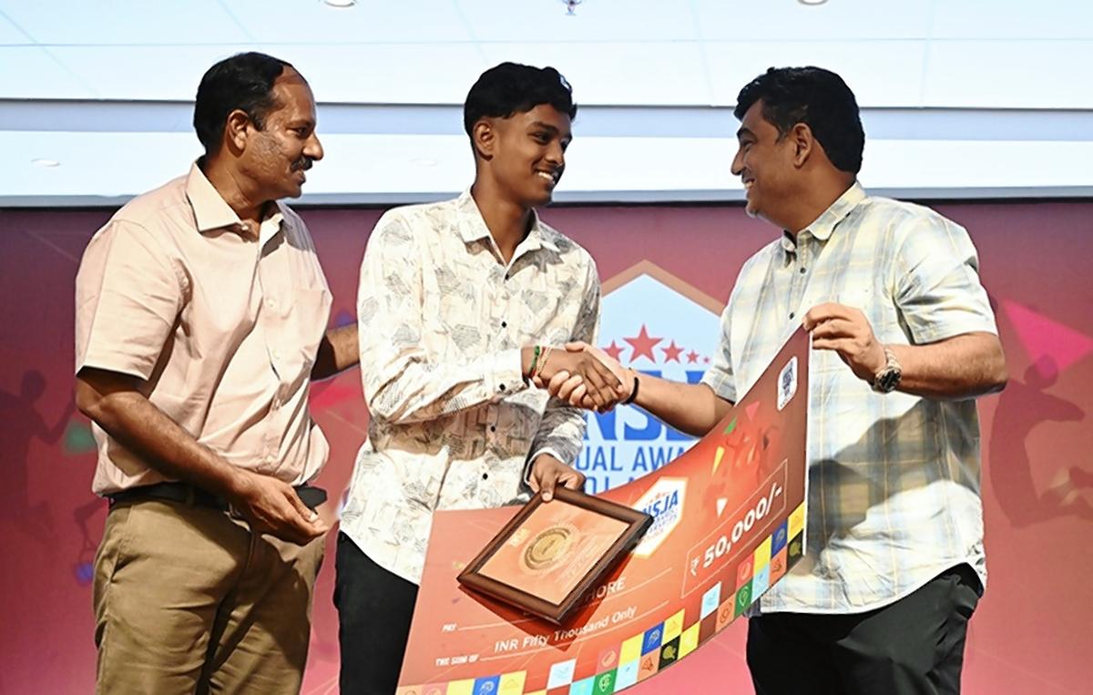 Mohammed Riaz and S. Sharath present the scholarship to B.K. Kishore.
