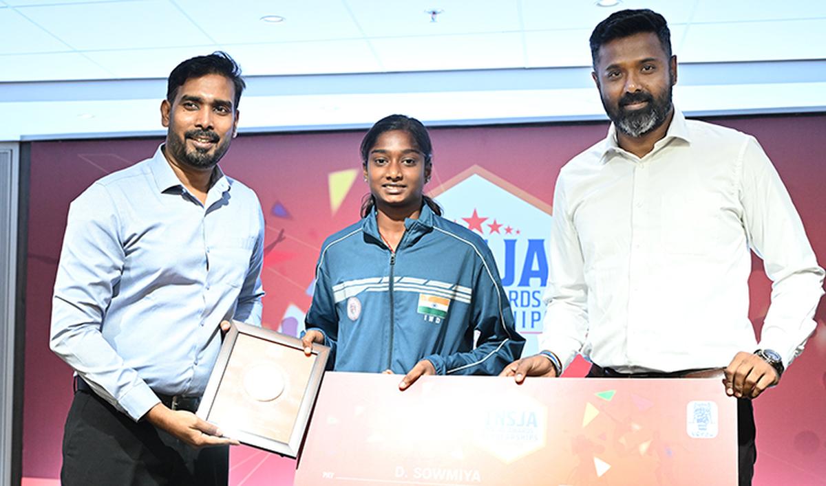 D. Sowmiya receives the scholarship from A. Sharath Kamal and M. Ukkrapandian.