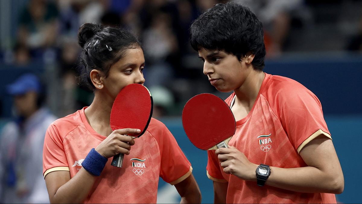 Sreeja Akula and Archana Girish Kamath of India speak with each other during their match against Yuan Wan and Shan Xiaona of Germany.