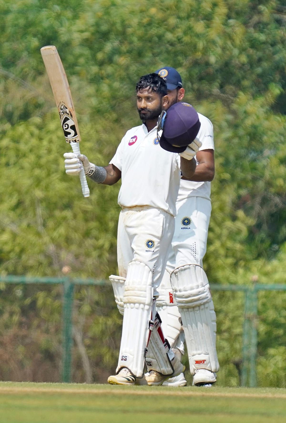 Akshay acknowledges the applause on reaching his hundred.