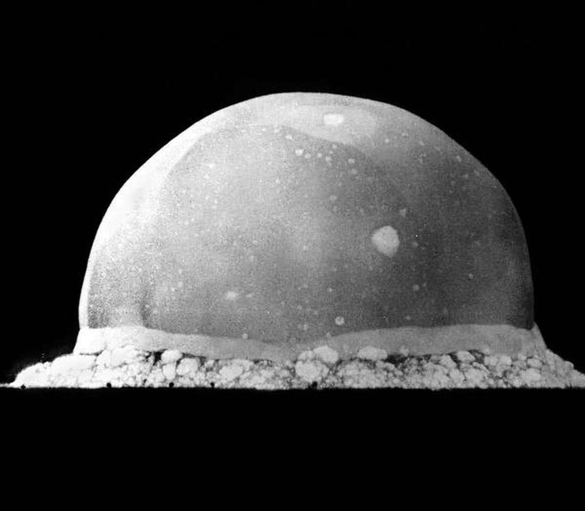 A black and white image of the first nuclear test at the Trinity site, seconds after the explosion took place.