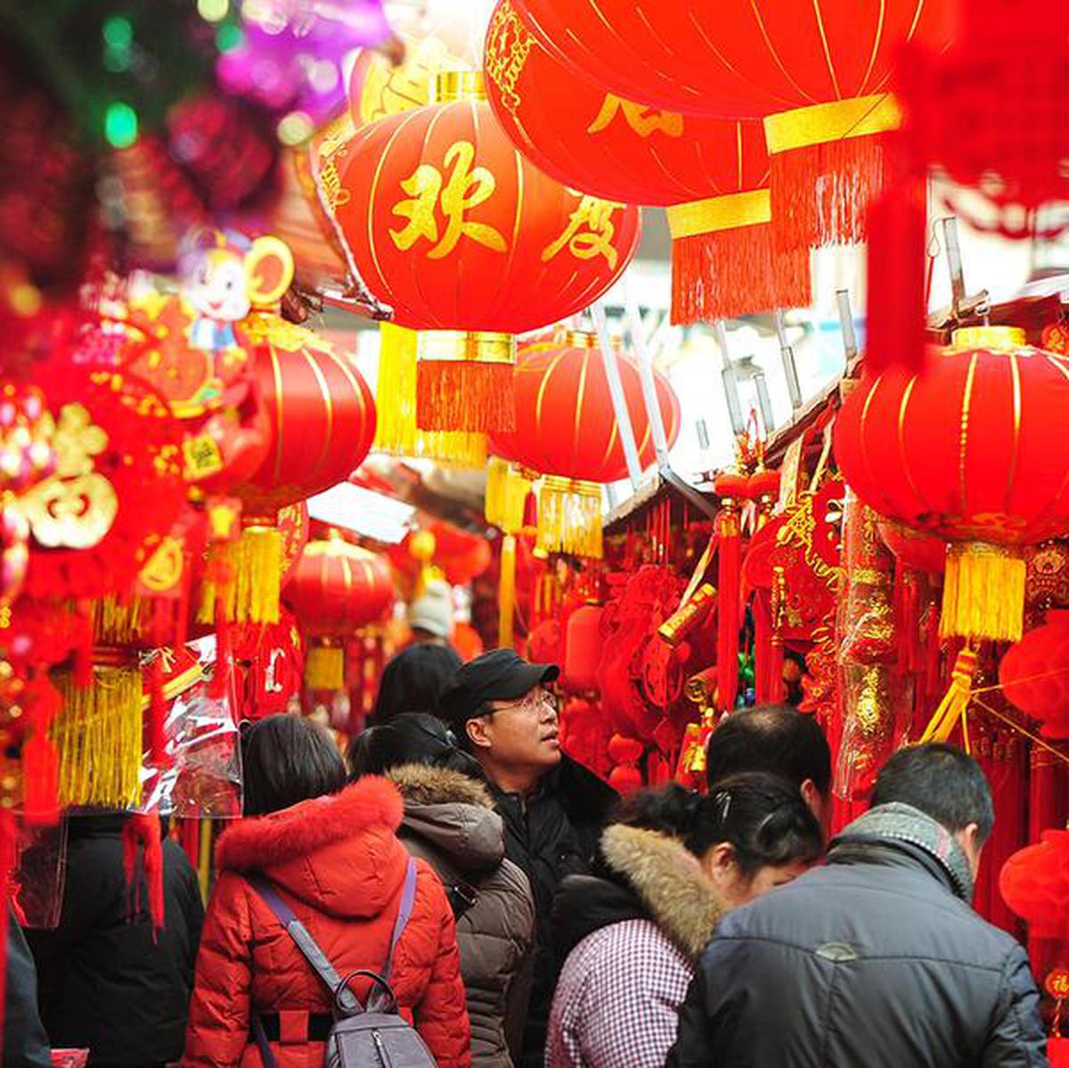 People buy decorations for the Lunar New Year at a market in Qingdao in China's eastern Shandong province on January 3, 2020.