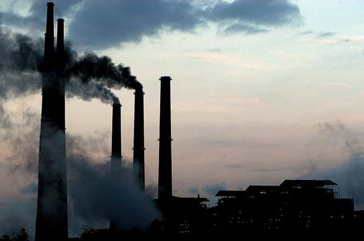 Smoke billows from the towering chimneys of the Kolaghat Thermal Power Station, 72 km from Kolkata, West Bengal.
