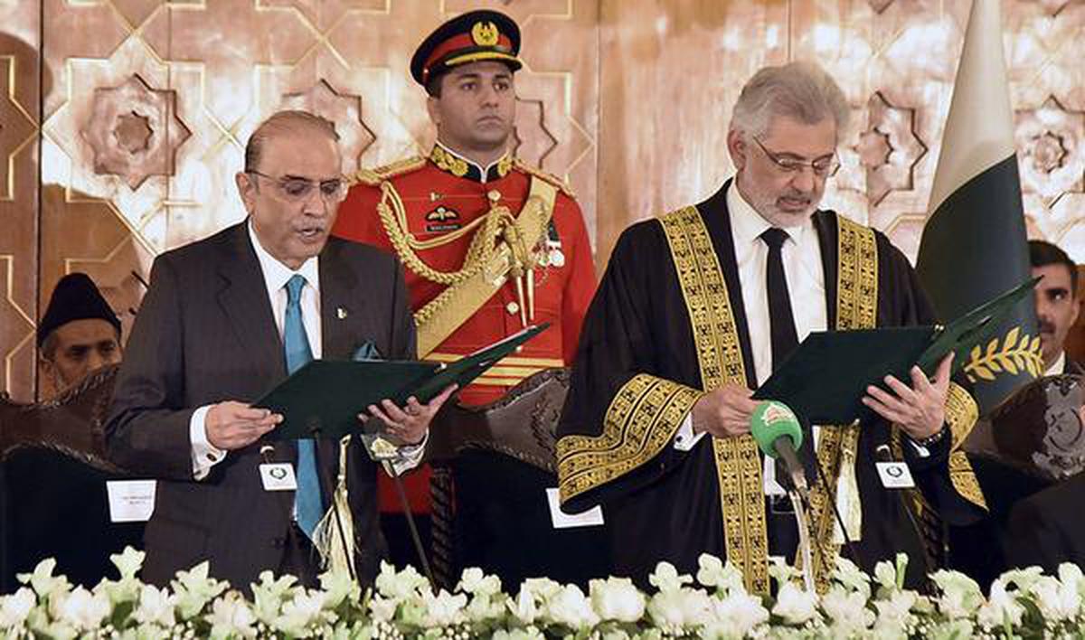 Chief Justice of Pakistan Qazi Faez Isa, right, administers the oath of office to Asif Ali Zardari at the Presidential Palace in Islamabad.  