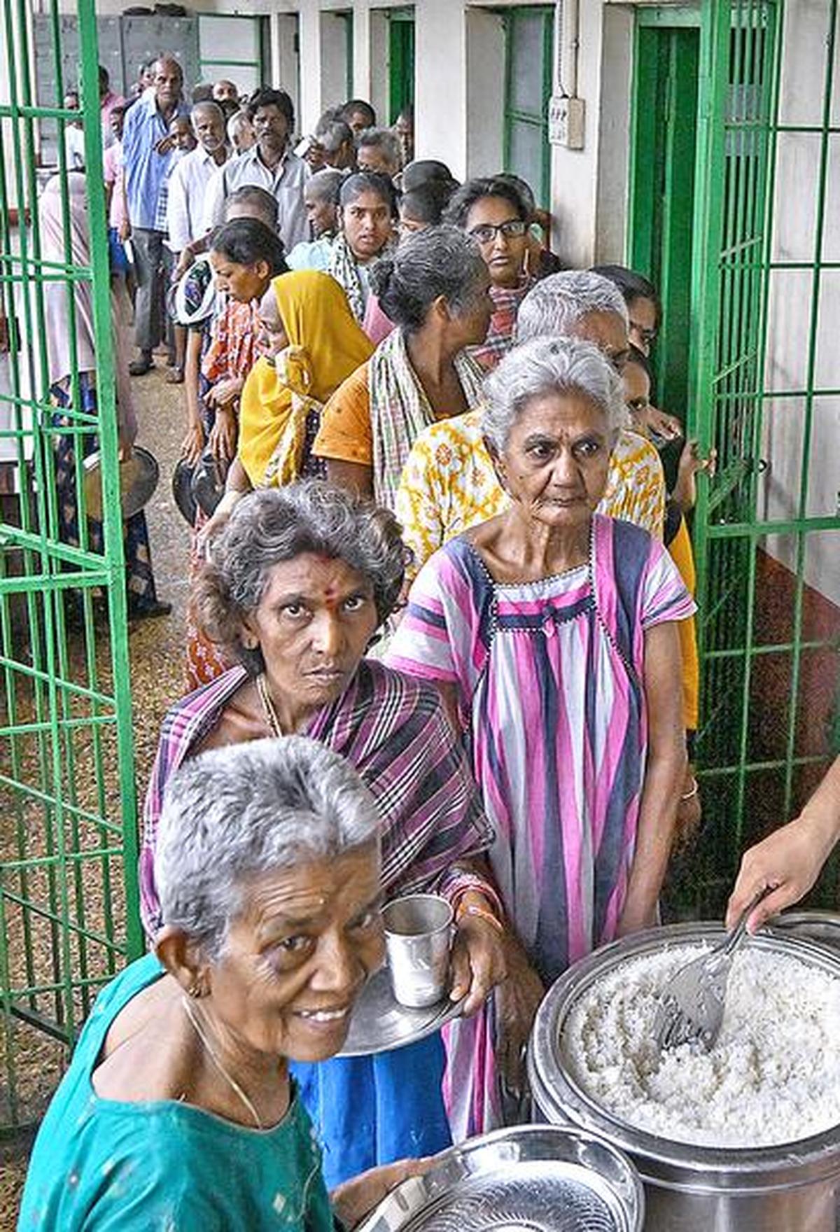 Inmates of GVMC Night Shelter at TSR Complex queuing for lunch Inmates of GVMC Night Shelter at TSR Complex queuing for lunch
