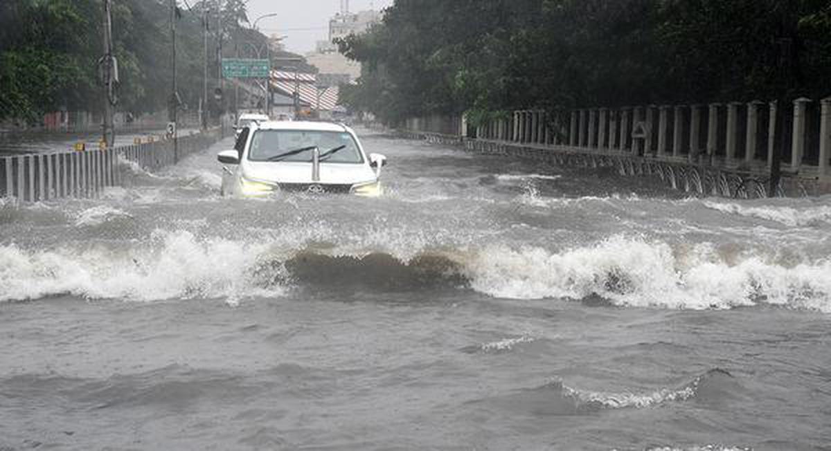 Vehicles struggling to cross the submerged Poonamallee High Road after heavy rains in Chennai, December 4, 2023.